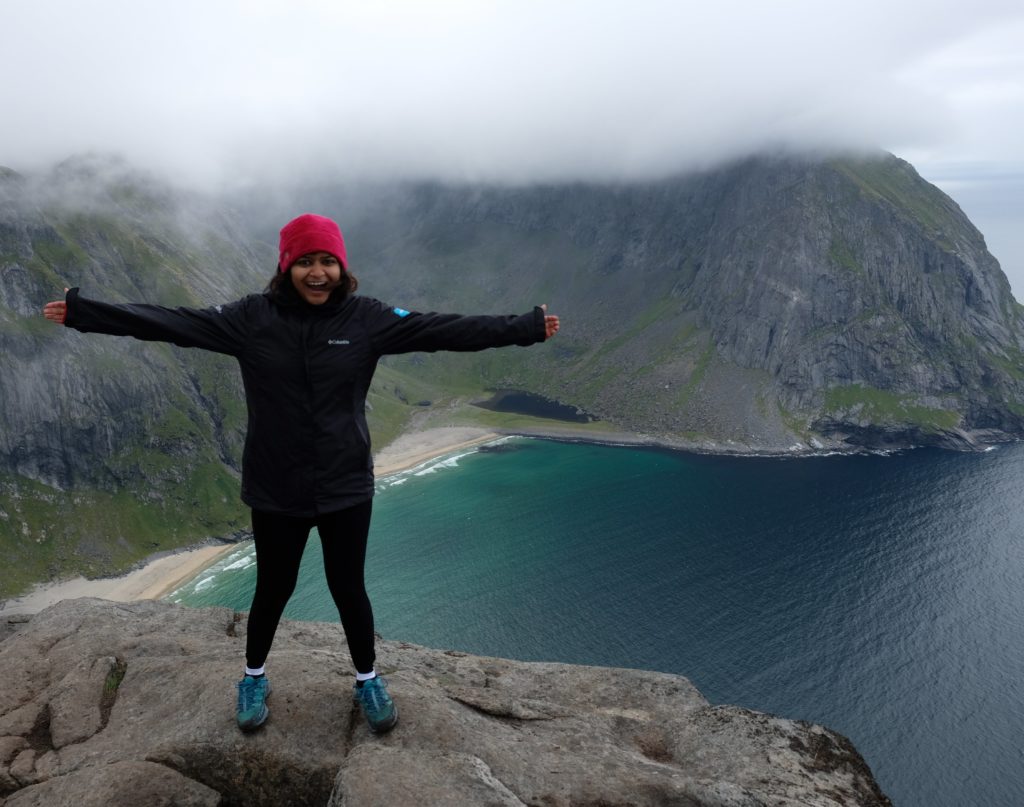 Photo: Astha Singhal standing on a mountain while hiking in Norway